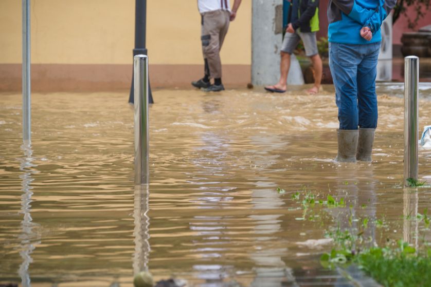 Man standing in high water after hurricane weather event